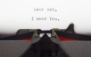 Prayer, letter to God writed on old typewriter. The need for God.